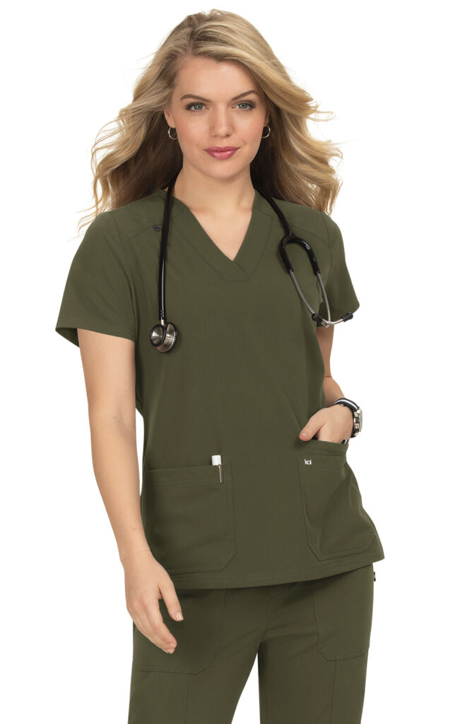 Woman posing in olive green medical scrubs in Ventura County California.