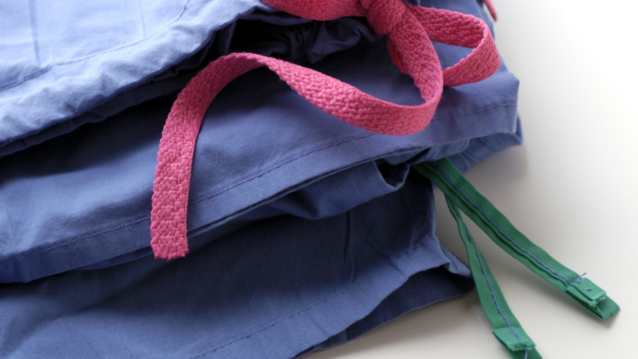 Stack of folded medical scrubs with a stethoscope in Ventura County California.
