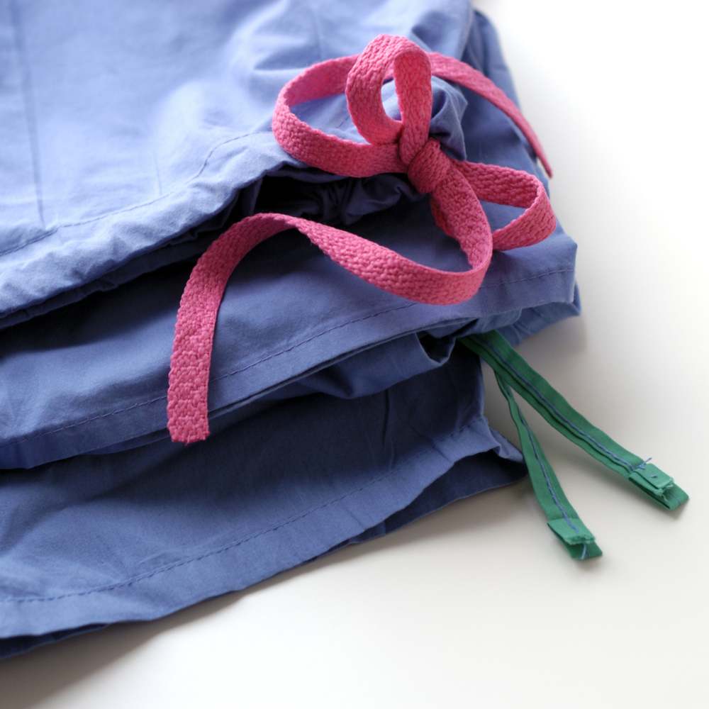 Stack of folded medical scrubs with a stethoscope in Ventura County California.