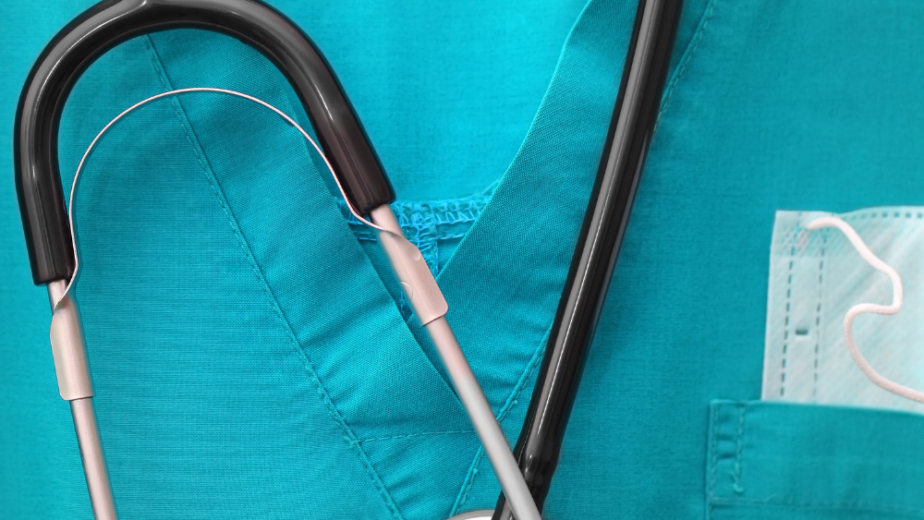Close-up of a stethoscope placed on green medical scrubs in Ventura County California. Modern Medical Uniform Fabrics technology in scrubs