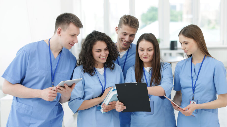 Learn how Ventura County Scrubs supports healthcare professionals with quality uniforms and personalized service. Group of medical students in uniforms indoors medical uniforms store Ventura County scrubs mission statement
