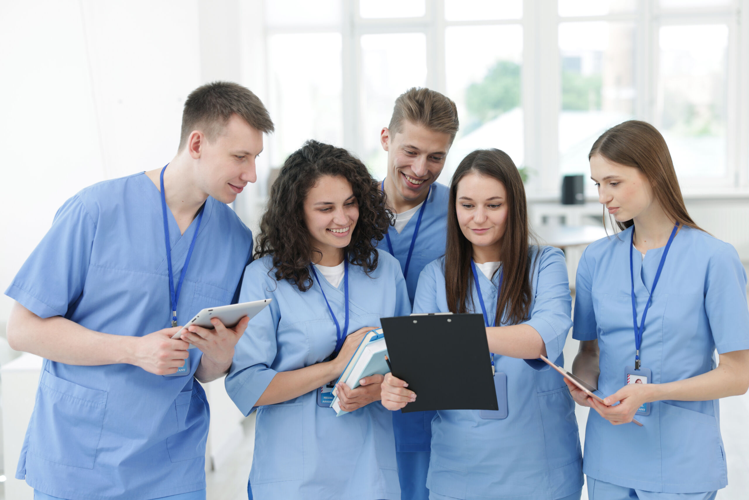 Learn how Ventura County Scrubs supports healthcare professionals with quality uniforms and personalized service. Group of medical students in uniforms indoors medical uniforms store Ventura County scrubs mission statement
